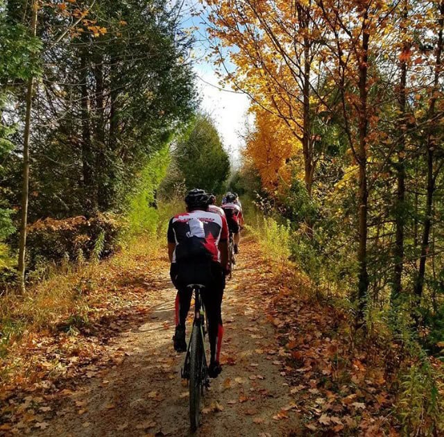 Cyclists riding on leaf covered trail in north Burlington