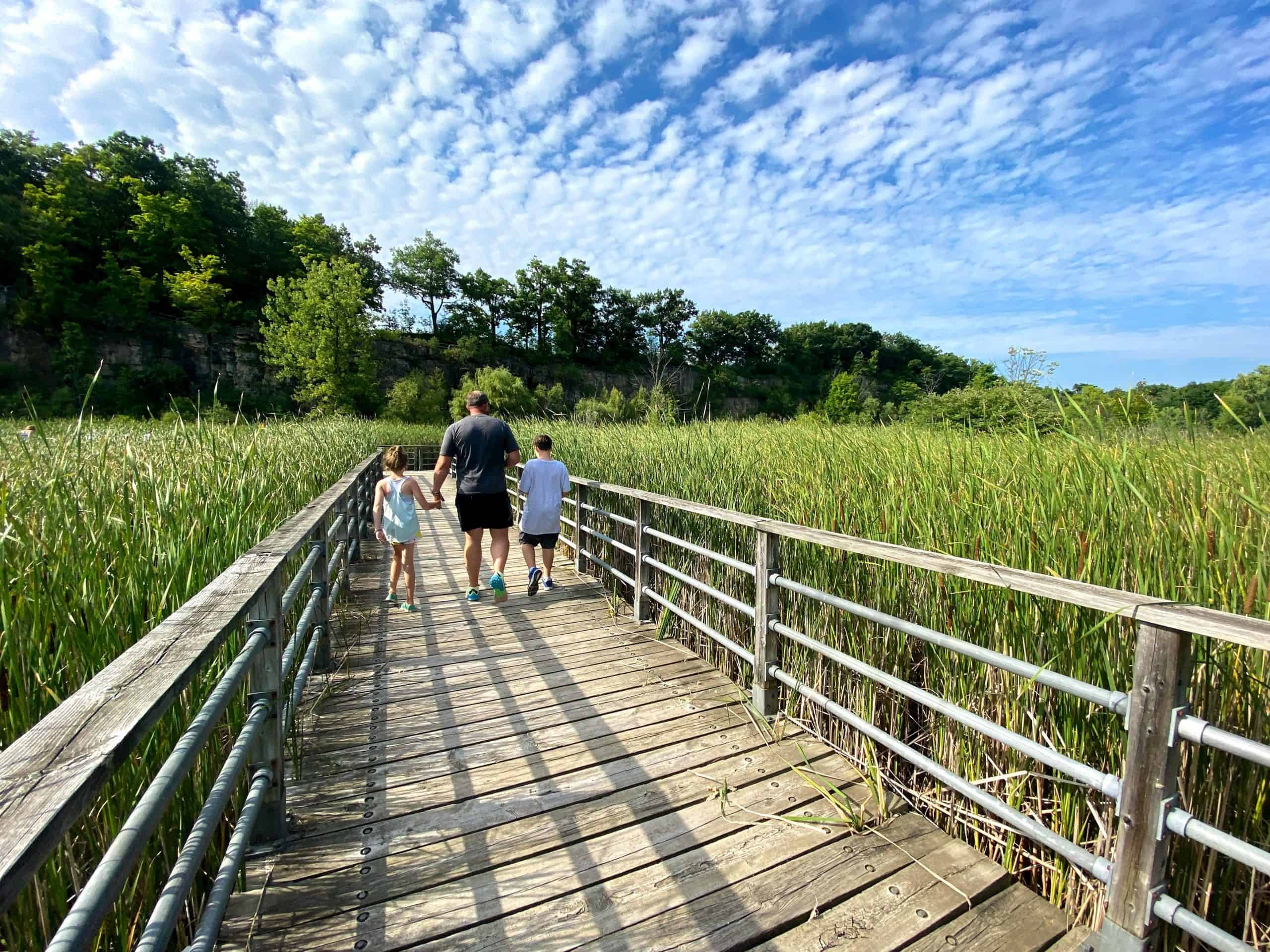 Family hiking on boardwalk