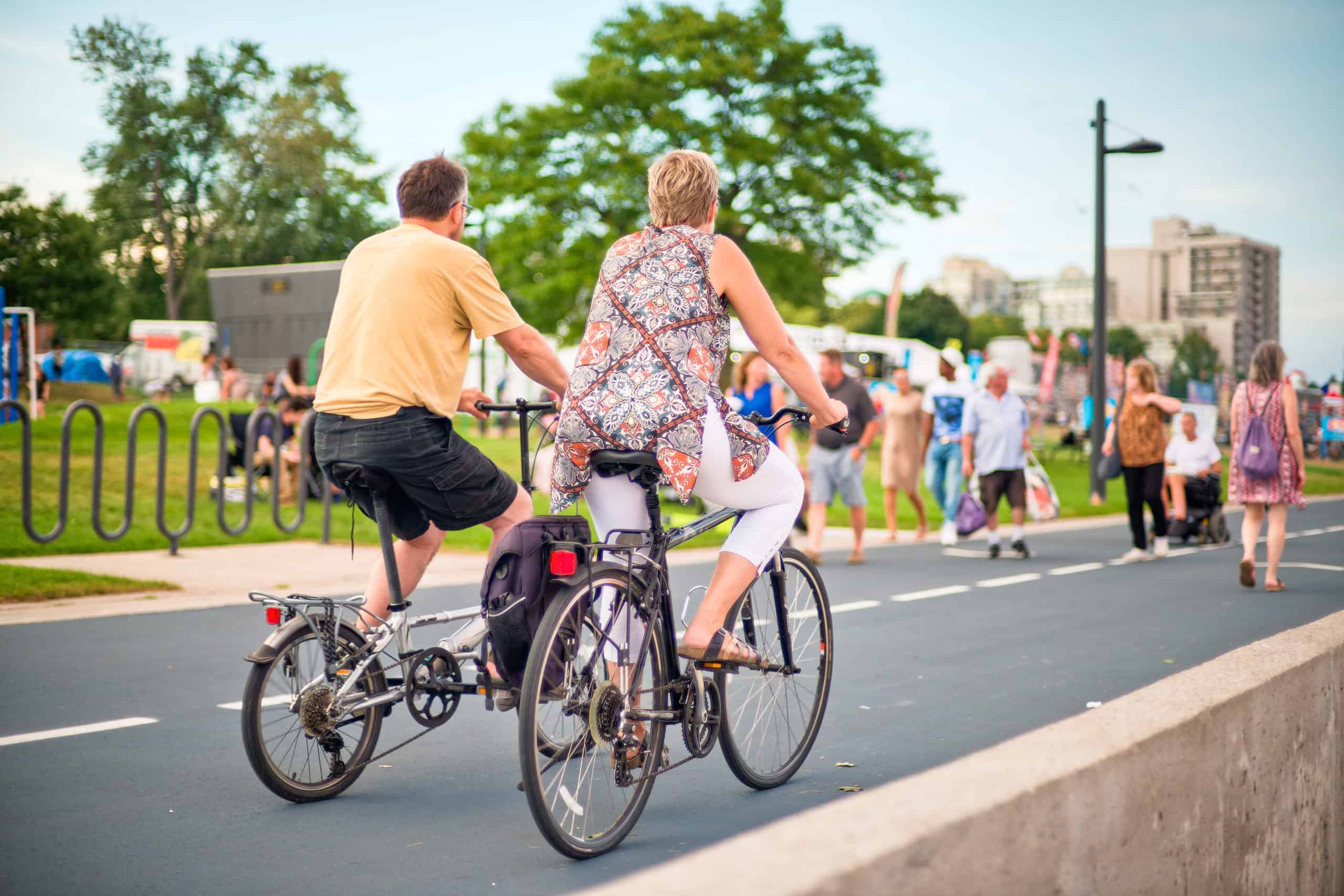 Couple riding bikes along promenade at Spencer Smith park