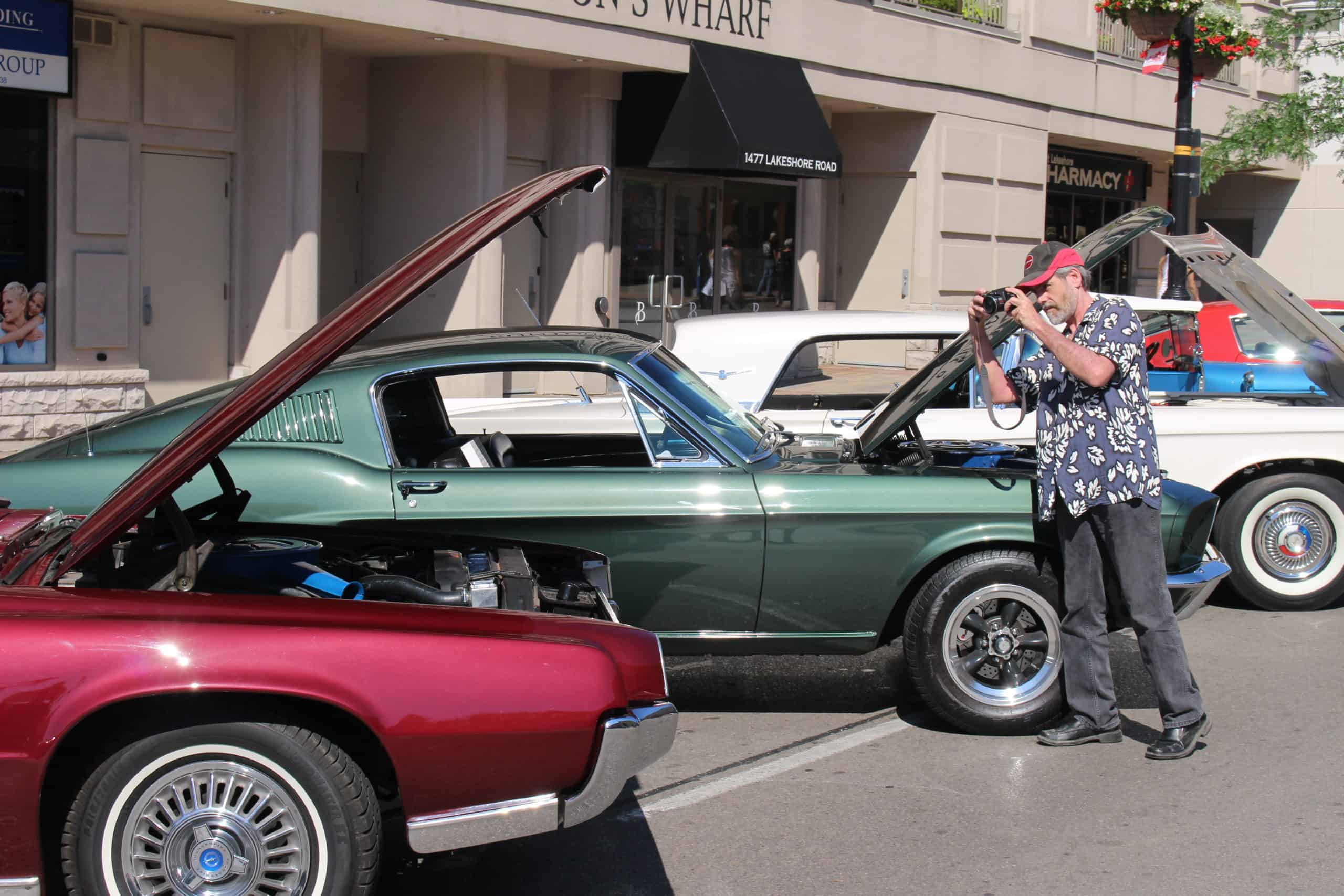 Man checking out classic cars at downtown show
