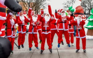 Kids in Santa suits jumping before Santa 5K