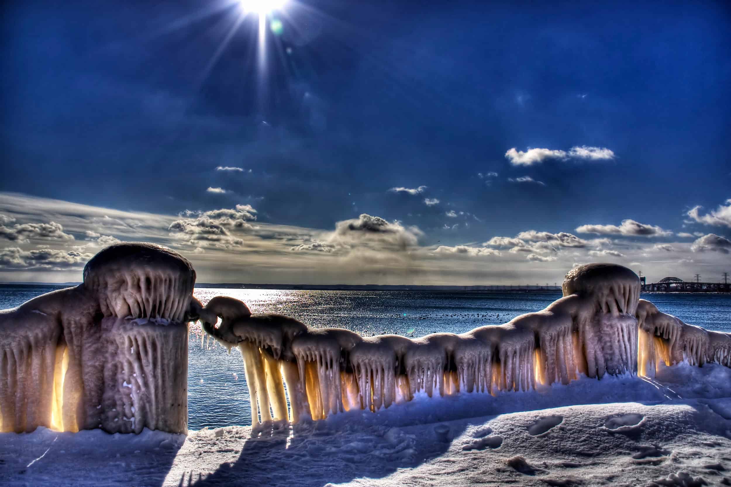 Bollards and chains along promenade covered in ice