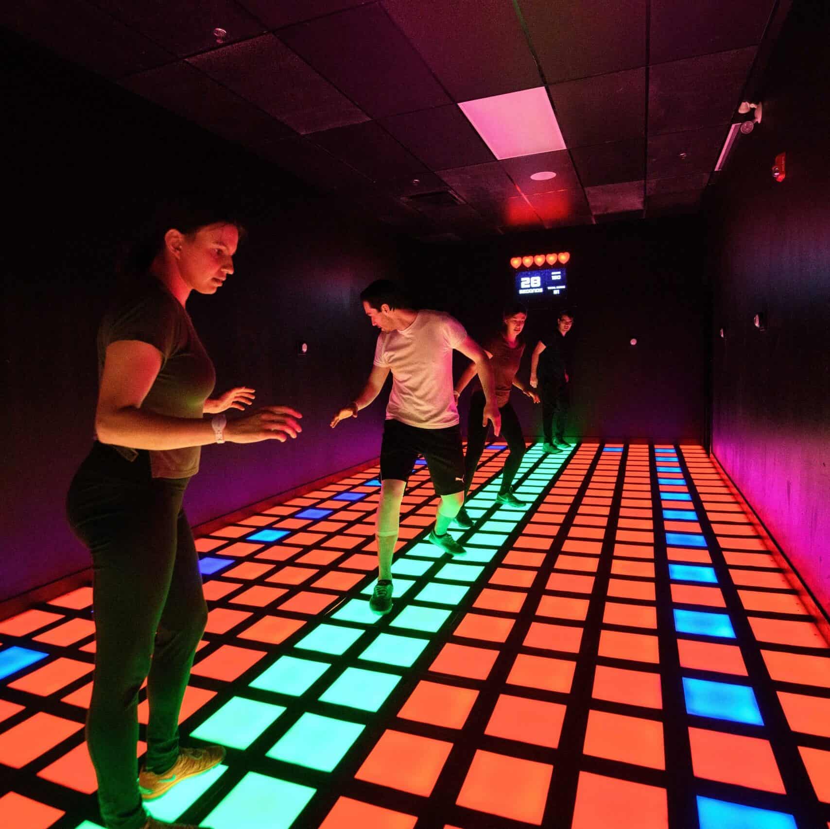 people playing activate with light up squares